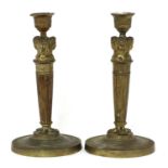 A pair of Empire gilt bronze candlesticks,