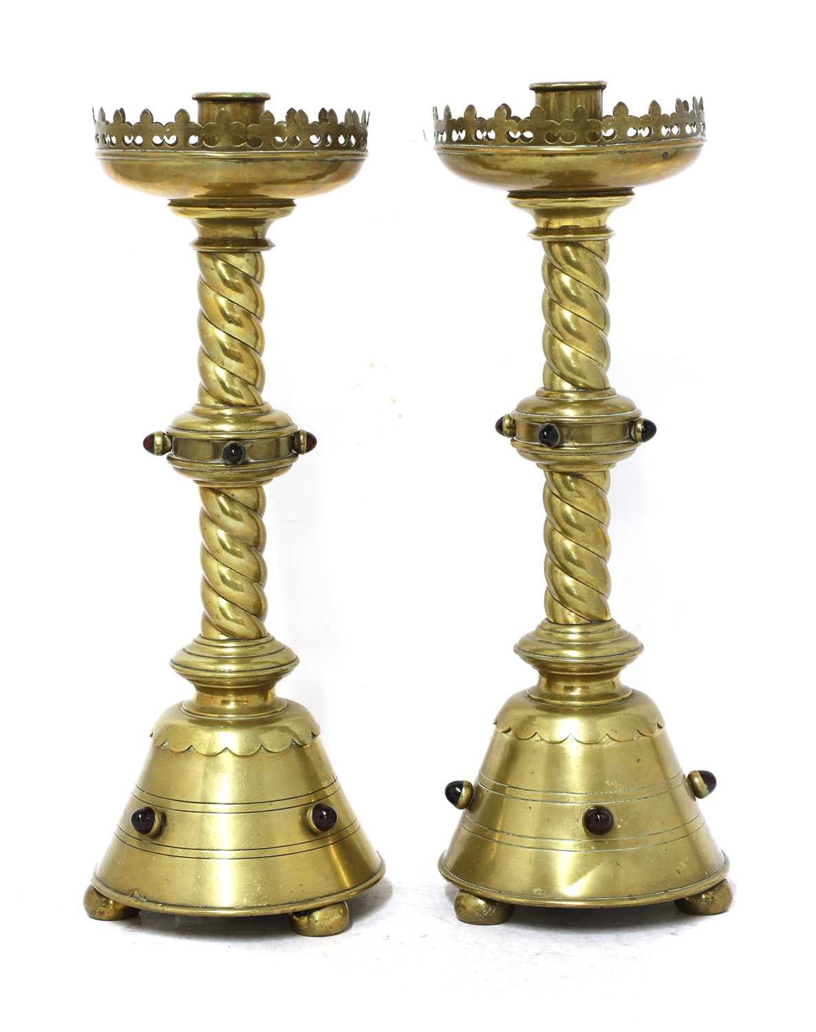 A pair of brass ecclesiastical candlesticks