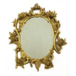 A carved giltwood rococo-style oval mirror,