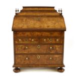 A walnut and feather banded bureau