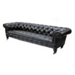 A large buttoned leather chesterfield sofa,