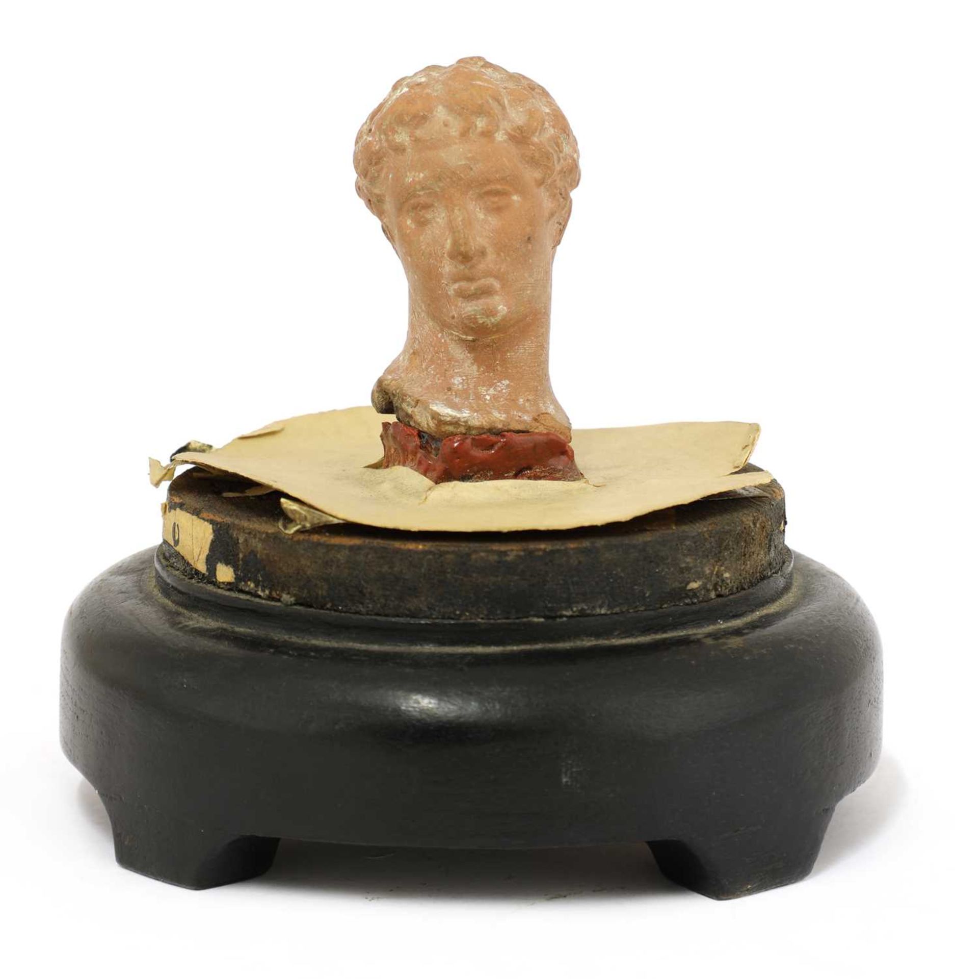 A Greek terracotta head of Apollo,
