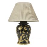 A black and gilt-glazed table lamp,