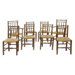 A matched set of eight oak and elm rush seated chairs