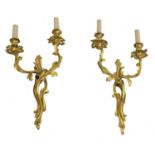 A pair of French rococo-style gilt-bronze wall lights,