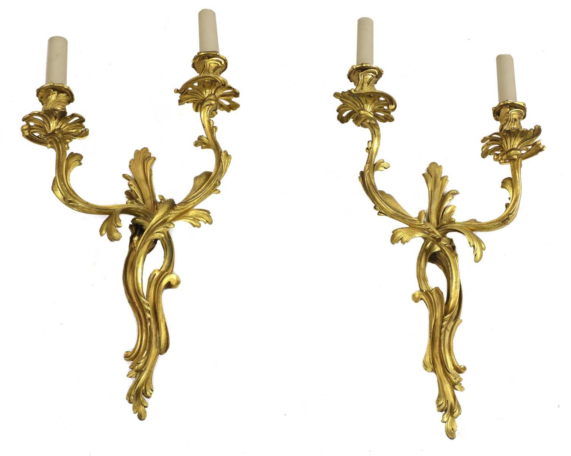 A pair of French rococo-style gilt-bronze wall lights,