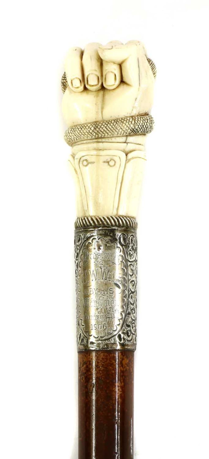 AN IVORY FIST CANE,