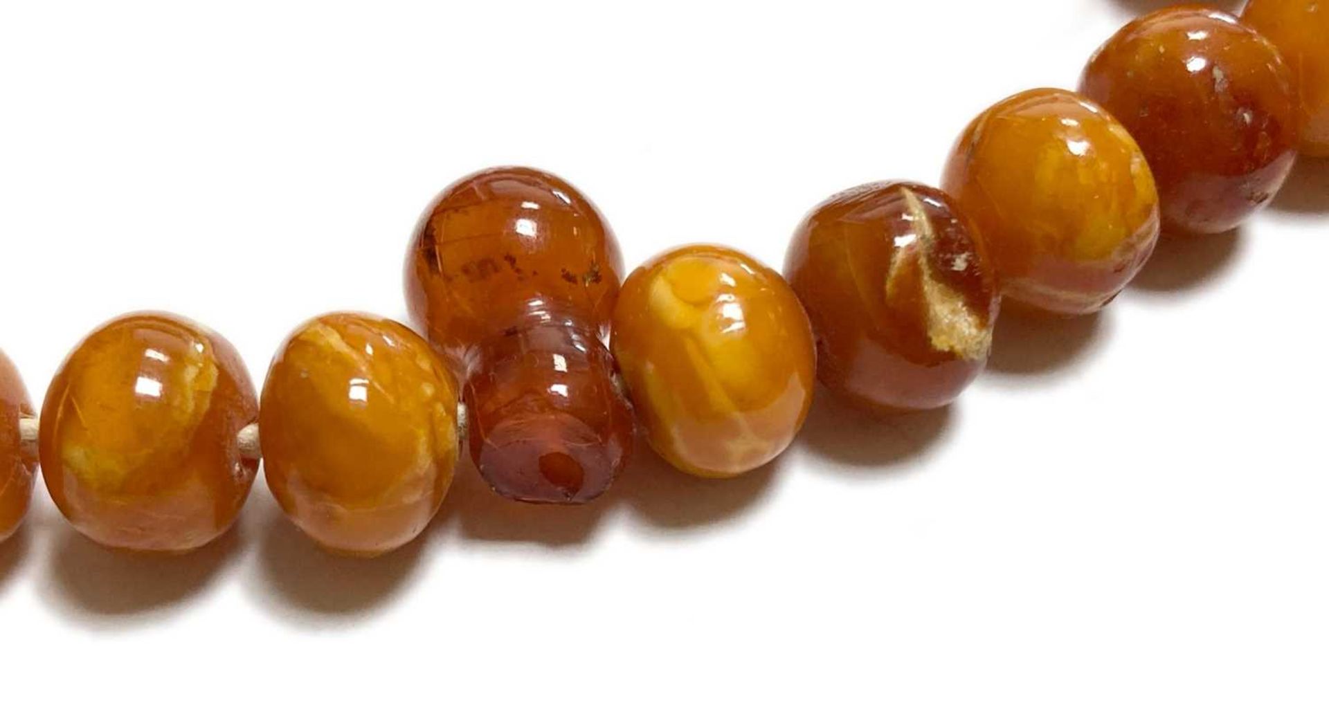 A single row slightly graduated butterscotch amber prayer bead necklace, - Image 9 of 15