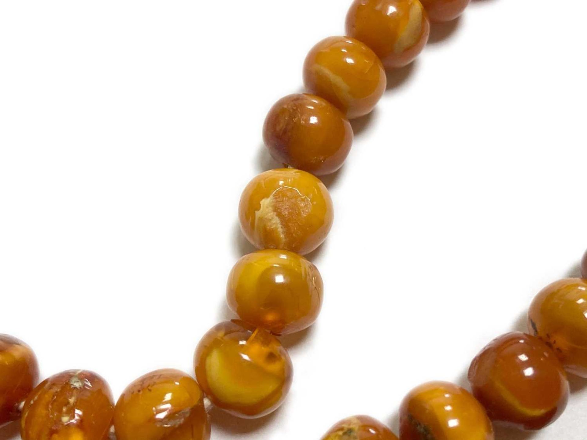 A single row slightly graduated butterscotch amber prayer bead necklace, - Image 5 of 15