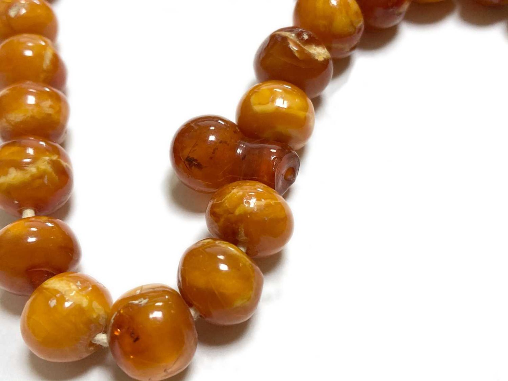 A single row slightly graduated butterscotch amber prayer bead necklace, - Image 10 of 15