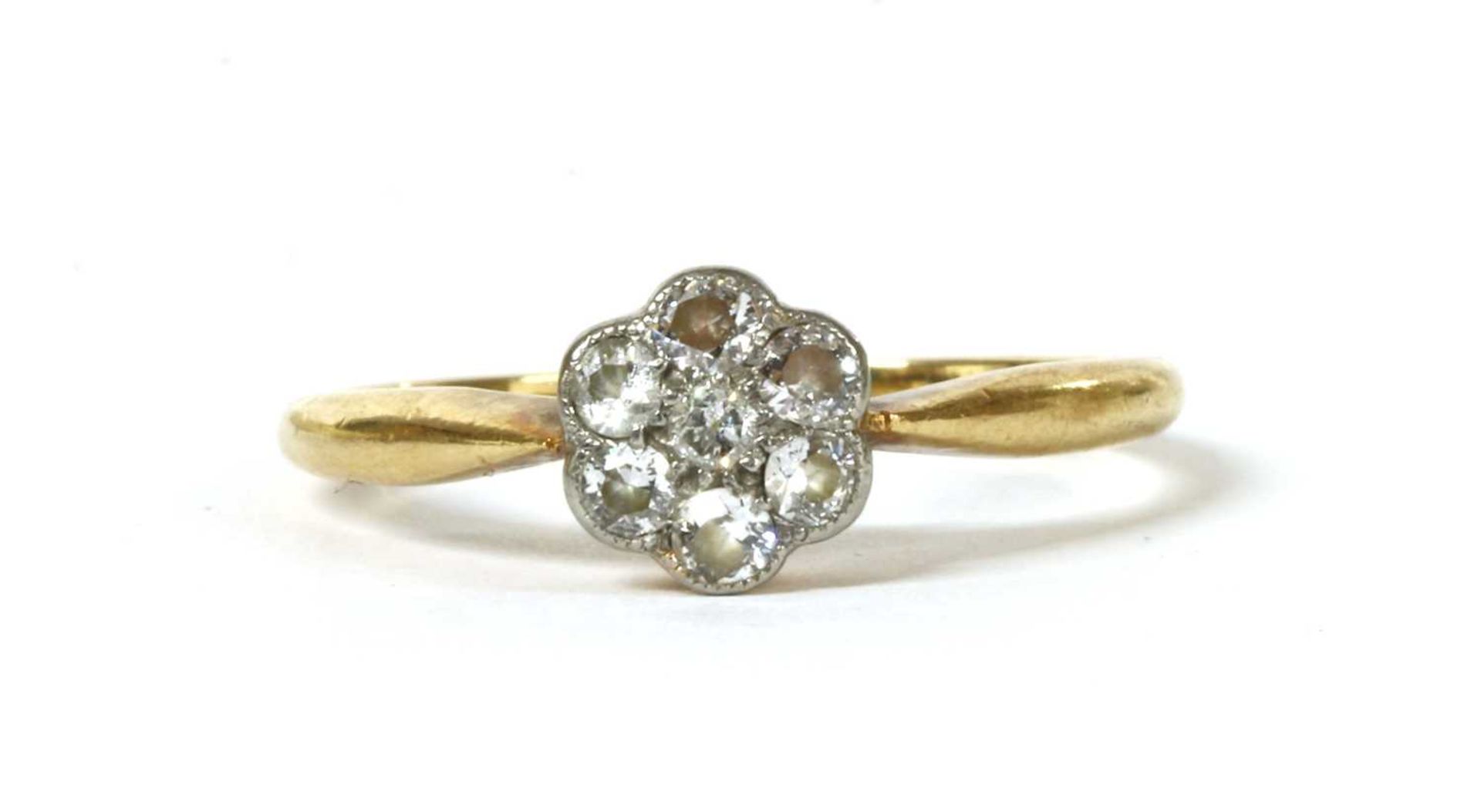 A gold diamond set daisy cluster ring,