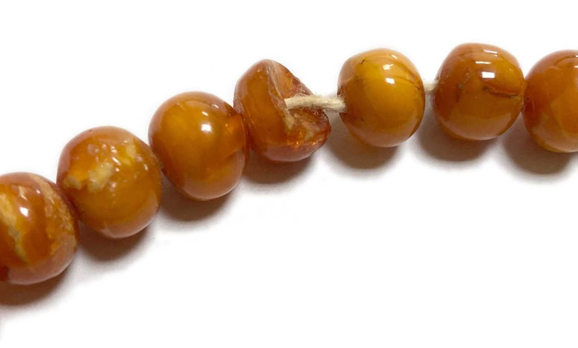 A single row slightly graduated butterscotch amber prayer bead necklace, - Image 6 of 15