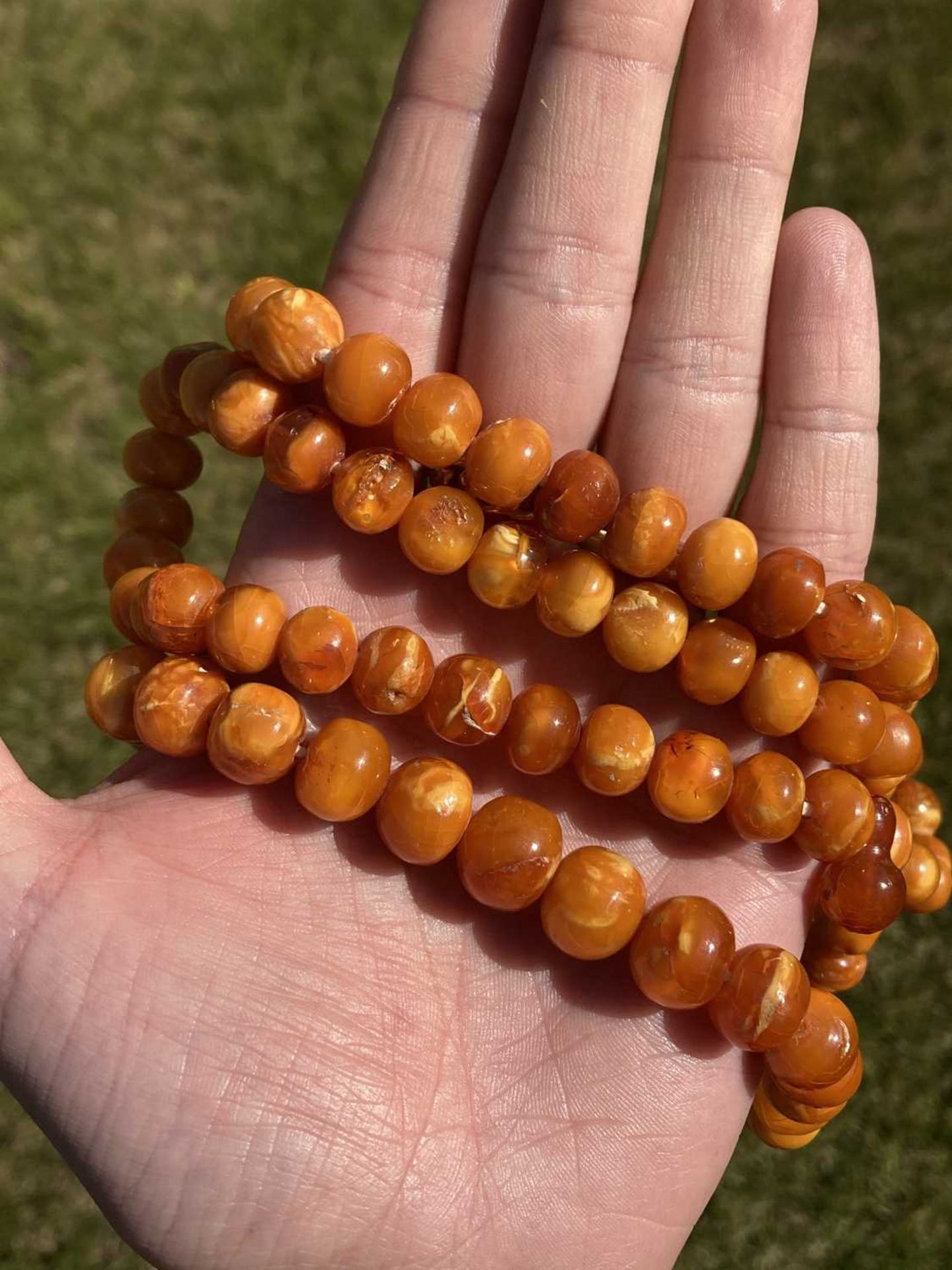 A single row slightly graduated butterscotch amber prayer bead necklace, - Image 15 of 15