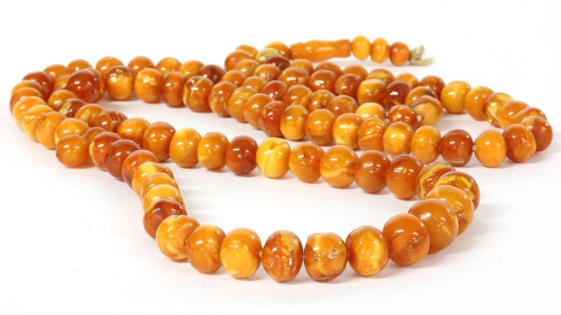 A single row slightly graduated butterscotch amber prayer bead necklace,