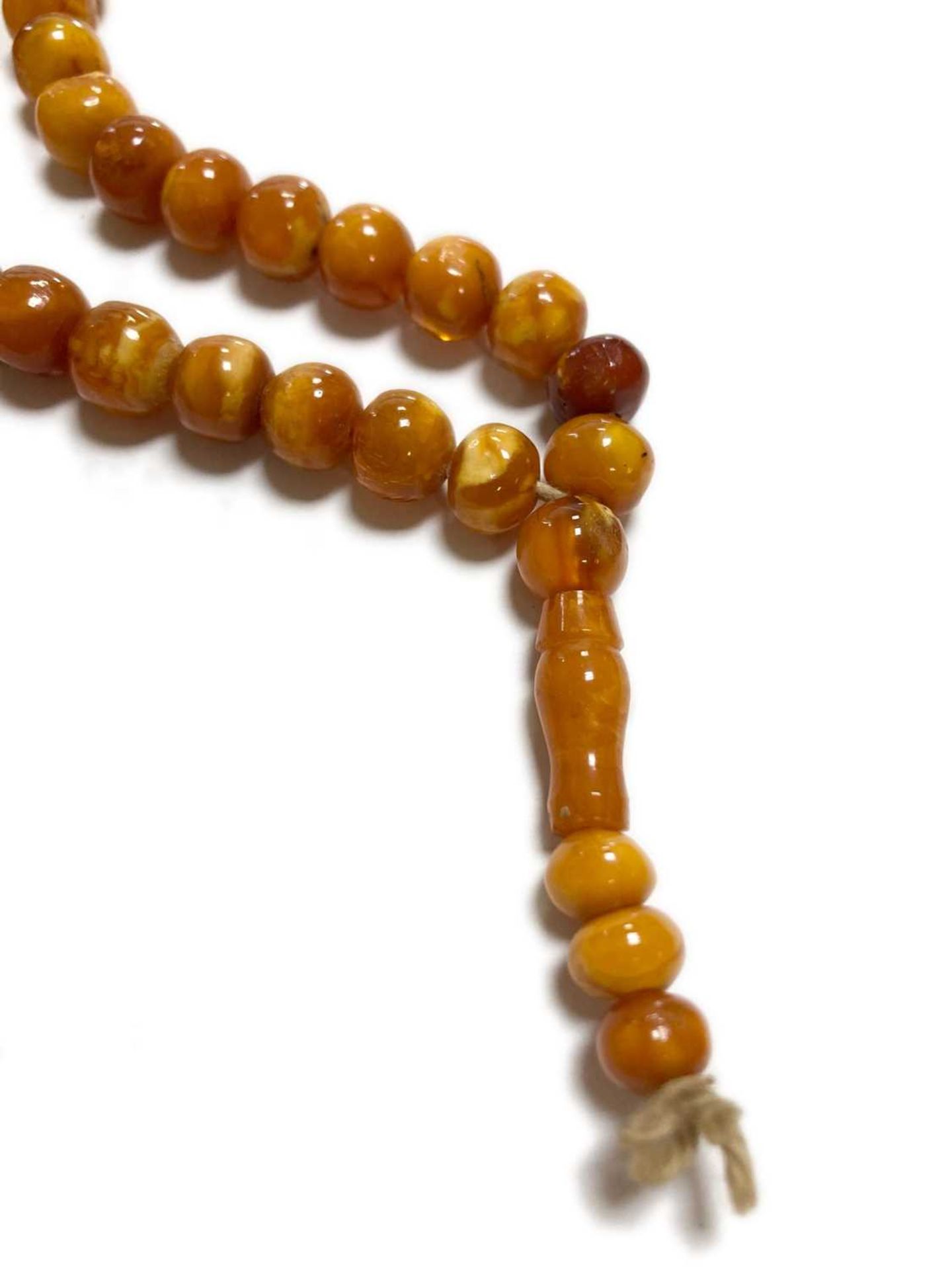 A single row slightly graduated butterscotch amber prayer bead necklace, - Image 3 of 15