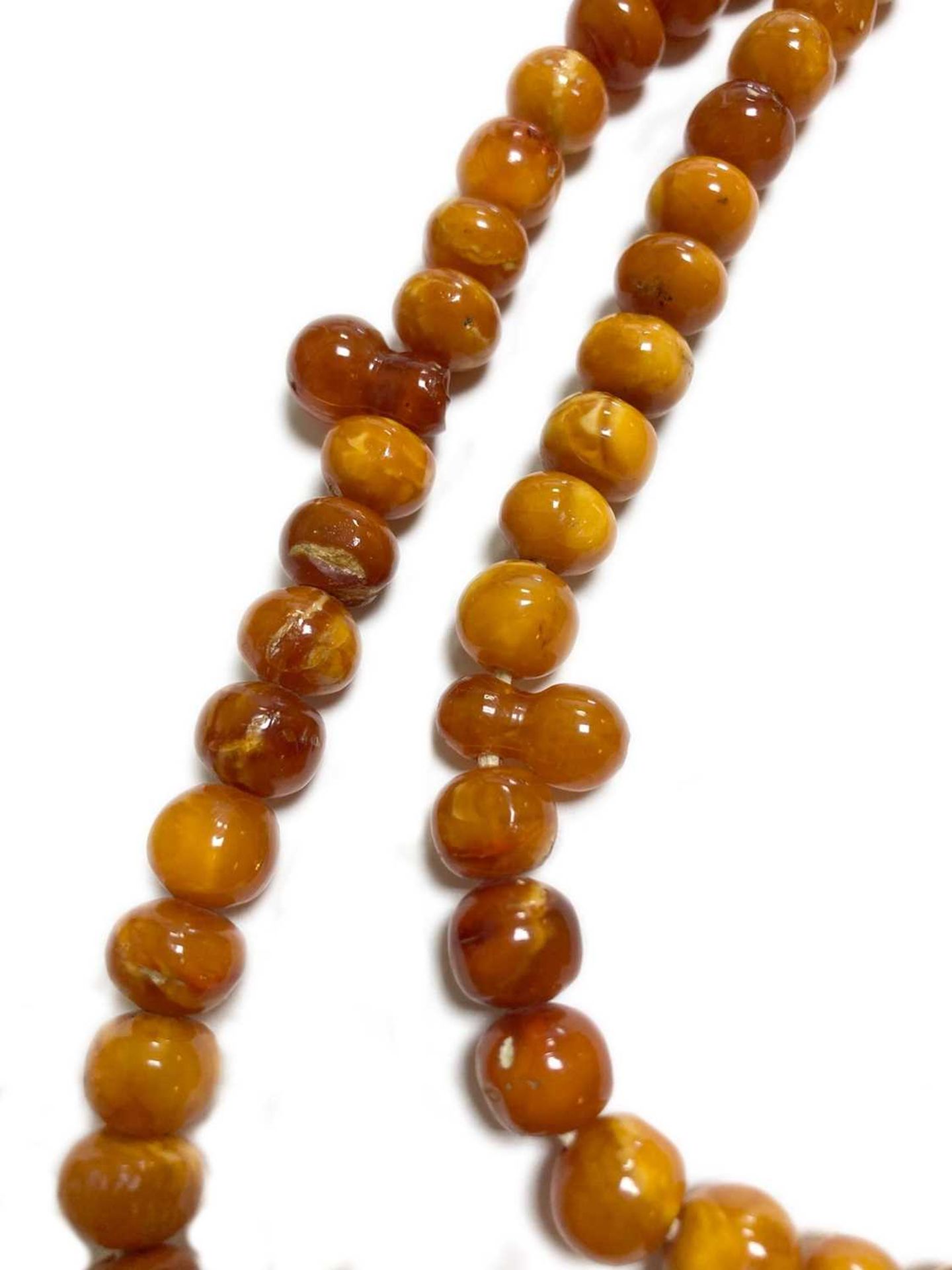 A single row slightly graduated butterscotch amber prayer bead necklace, - Image 4 of 15