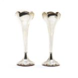 A pair of Edwardian silver vases with six sided tulip shaped bowls,
