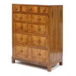 A walnut crossbanded chest of drawers,