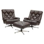 A pair of chocolate brown lounge chairs,