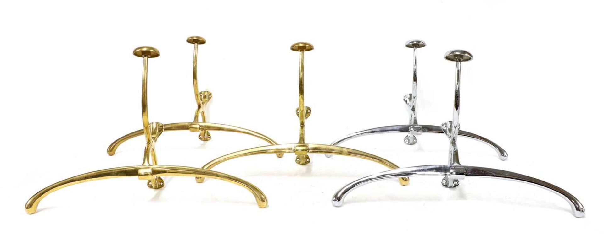 A collection of five brass and chrome coat hangers,