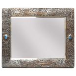 An Arts and Crafts embossed copper mirror,