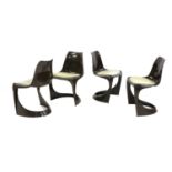 A set of four moulded brown chairs,