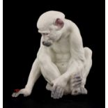 A porcelain figure of a monkey observing a ladybird,