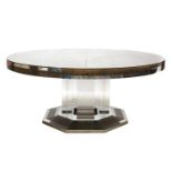 A massive circular glass panelled dining table,