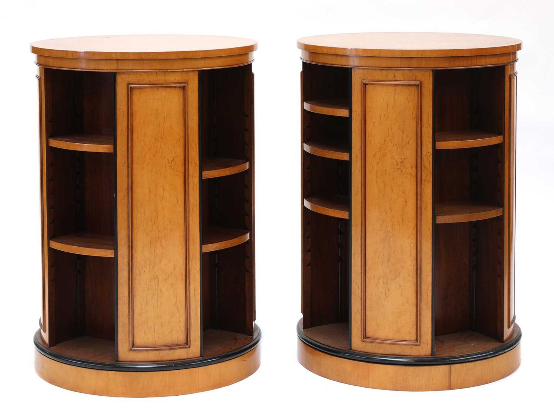 A pair of maple veneered revolving bookcases,