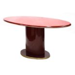 An Italian red lacquer and brass dining table,