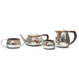 An Arts and Crafts pewter and copper mounted four-piece tea set,