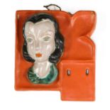 A small Goldscheider pottery wall mask calendar,