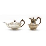 A silver teapot and hot water jug