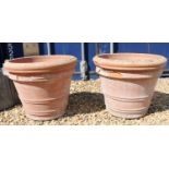 A pair of terracotta garden planters,