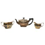 A silver three piece tea set,