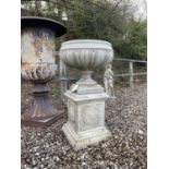 A composite stone garden urn
