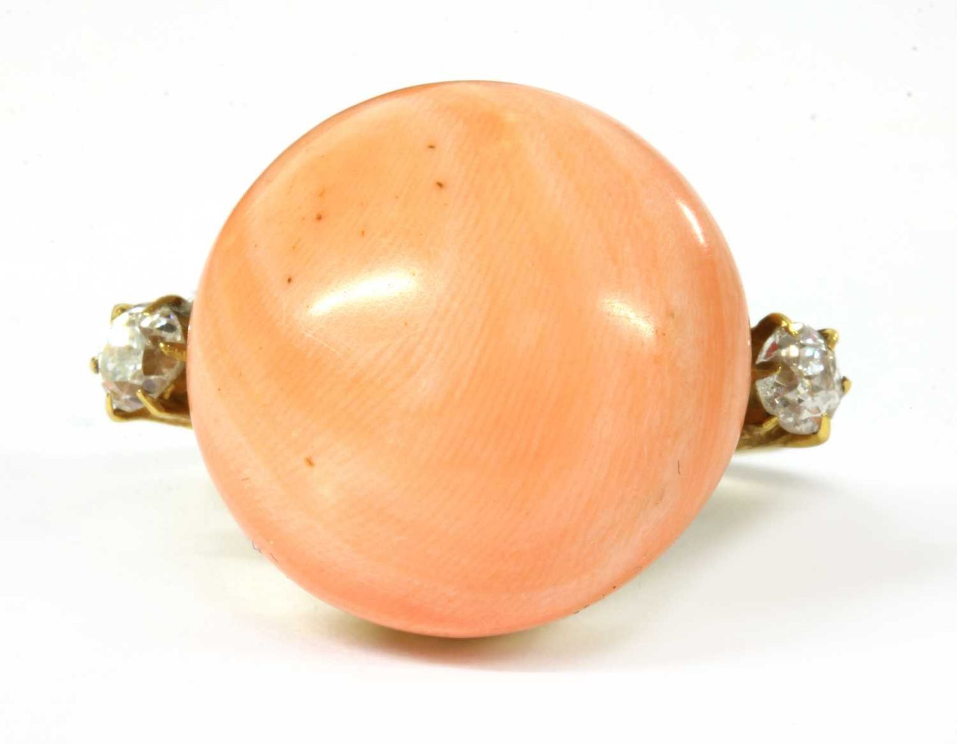 A gold coral and diamond ring,