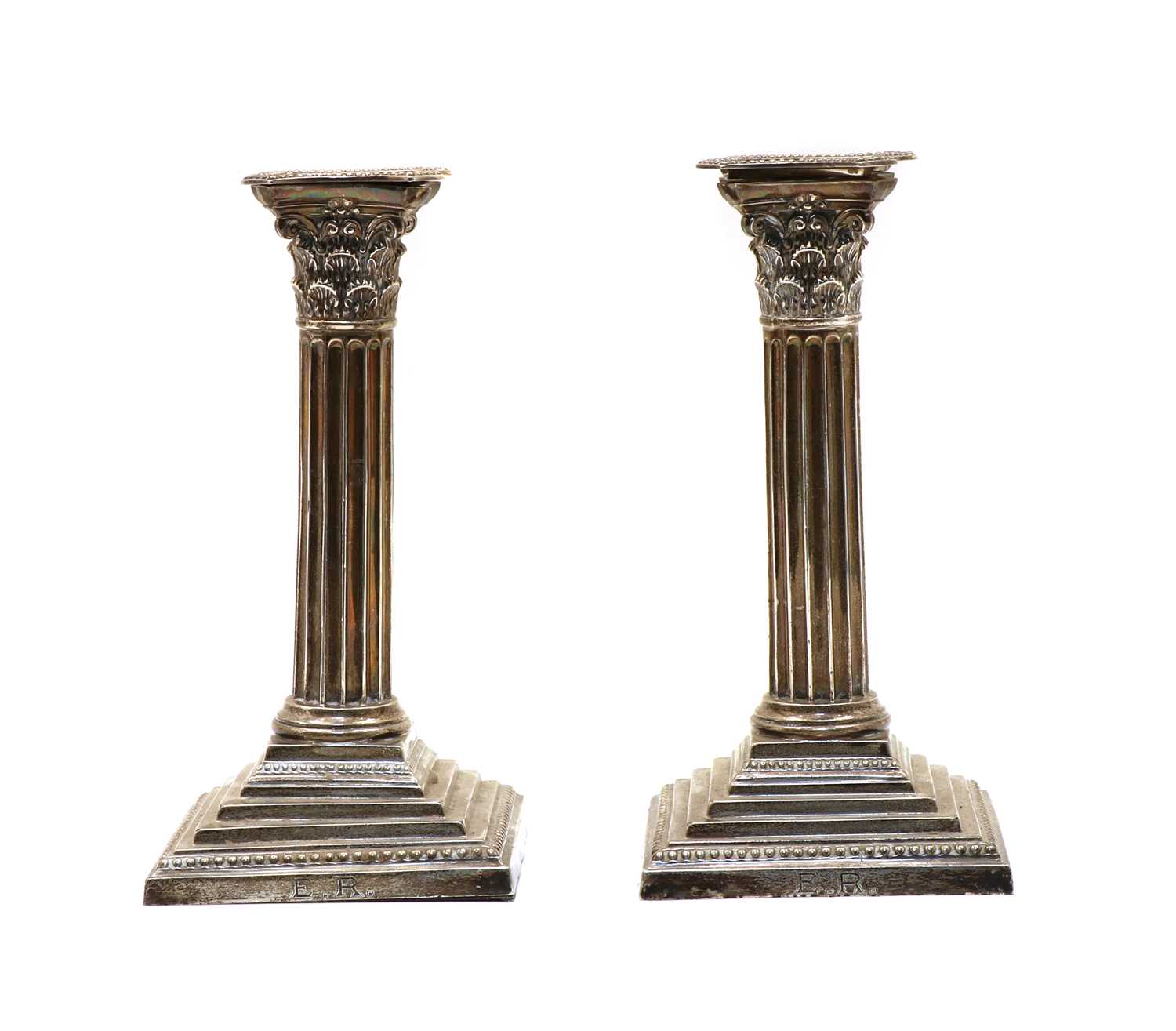 A pair of silver Corinthian column candlesticks,