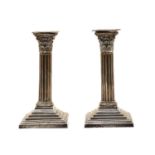 A pair of silver Corinthian column candlesticks,