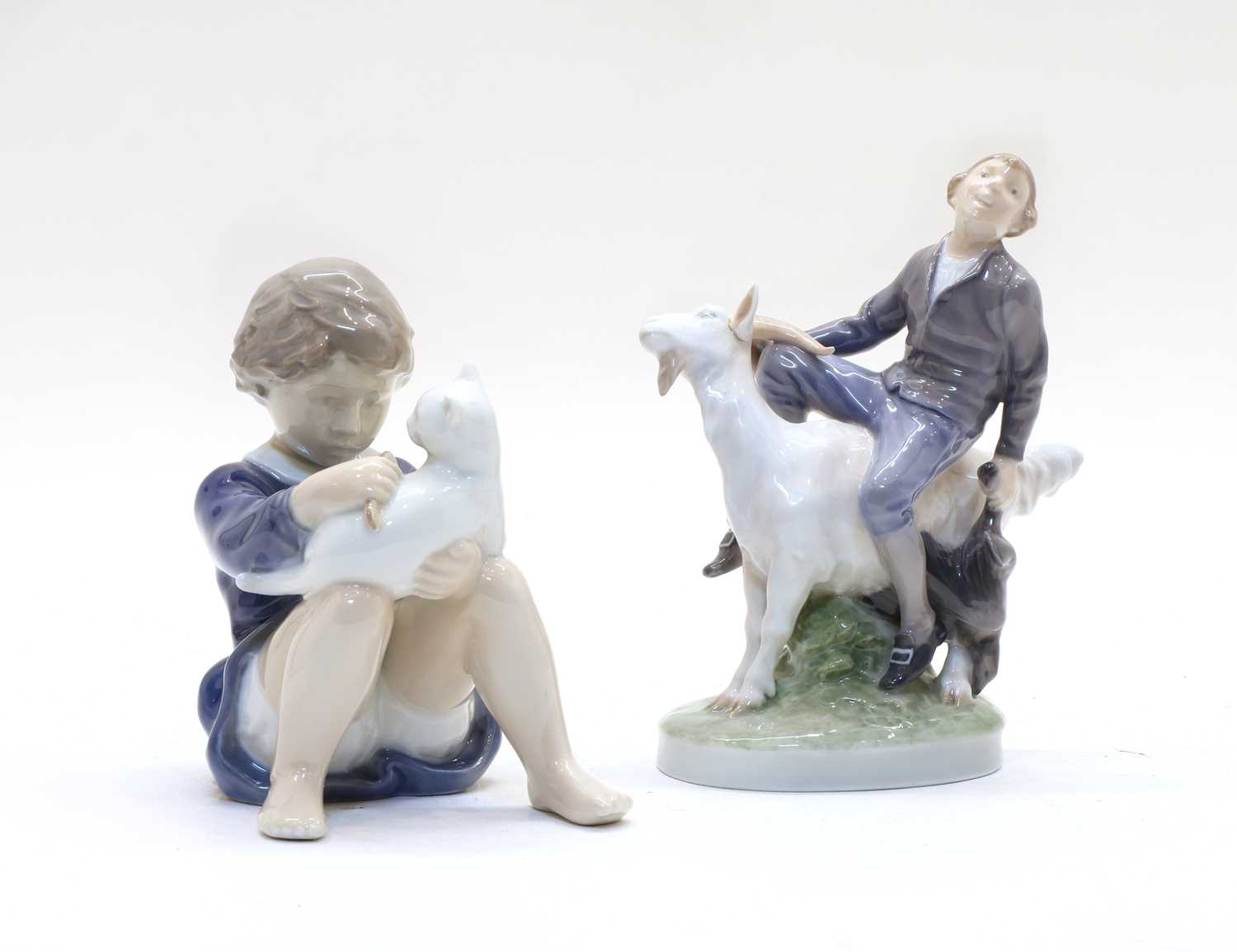 A Royal Copenhagen figure of a boy riding a goat,