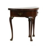 A George II mahogany demi-lune foldover tea table,