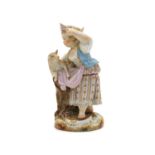 A Meissen figurine of a shepherdess with a lamb,