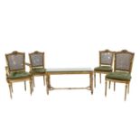 A set of four Louis XVI style painted elbow and giltwood chairs,