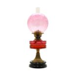 A Victorian cranberry glass oil lamp,