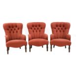 A set of three matching armchairs,