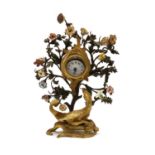 A German gilt metal and floral porcelain mounted drum head clock