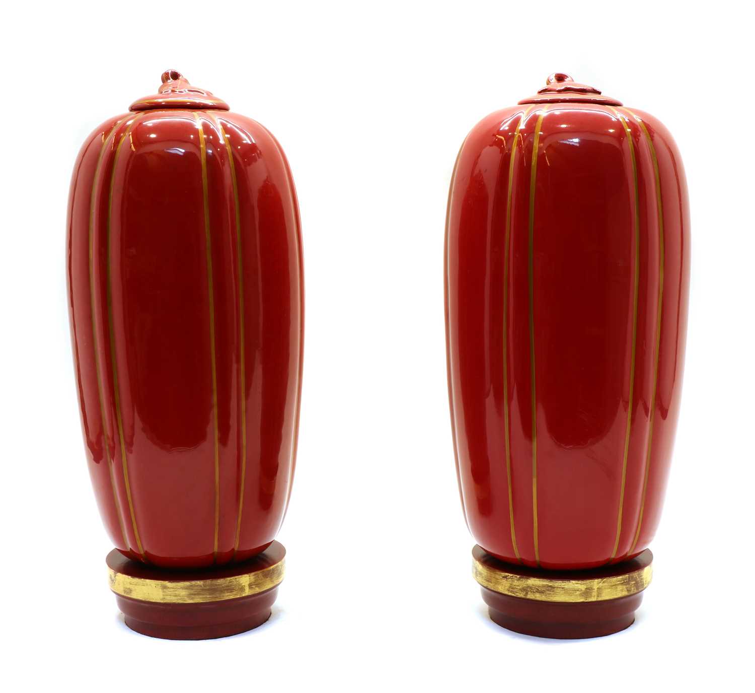 A pair of red-glazed and gilt-heightened porcelain vases,