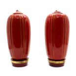 A pair of red-glazed and gilt-heightened porcelain vases,