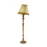 A carved gilt wood standard lamp and shade,