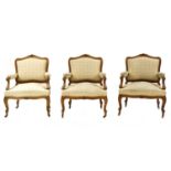 A series of three Austrian walnut framed upholstered armchairs,